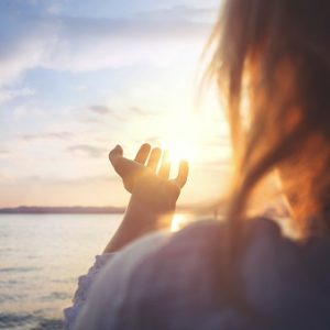 woman try to grab the sun